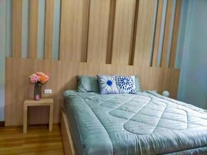 a bedroom with a bed with a wooden head board at Aonang Homie Pool villa in Ao Nang  +21 photos