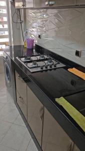a kitchen with a stove top oven in a kitchen at Lune in Sidi Yahia az Zaʼer