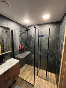 a bathroom with a shower and a sink at Modern apartment with Private parking - 10 min to airport, 15 min Center in Vilnius +25 photos