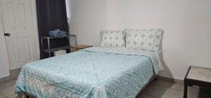 a bedroom with a bed with a blue comforter at Habitación en villa Costa del sol in Los Blancos +17 photos
