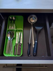 a drawer with some utensils in a cabinet at Városközpont Tata in Tata