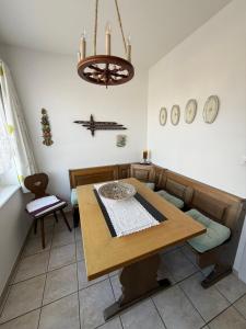 a dining room with a table and a chandelier at Urlaub am Bodensee in Staad - einmalige Seesicht in Staad