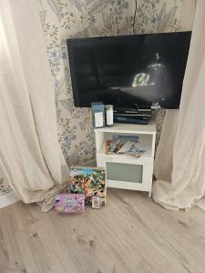 a flat screen tv sitting on top of a tv stand at mobil-home in Souméras
