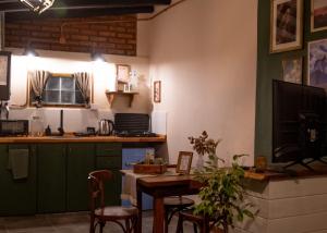 a kitchen with a table and some chairs and a counter at Aware in Capilla del Monte