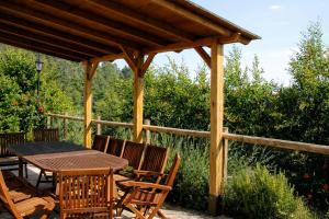 a wooden pavilion with a table and chairs at Casa con piscina y vistas a montaña - Cal Solsona in La Baronia de Rialb