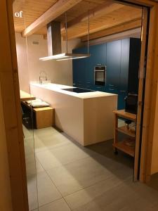 a kitchen with a sink and a counter top at Chalet Taulei tra Bormio e Livigno in Valdidentro