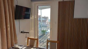 a dining room with a table and a sliding glass door at D,apartman' ulica pušća 51, 51513 Omišalj in Omišalj +92 photos