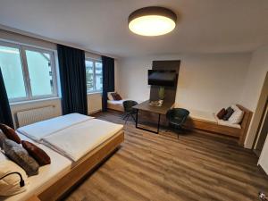 a bedroom with a bed and a desk and a couch at Thalinger Hof in Kronstorf