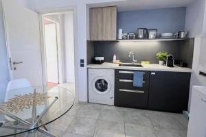 a kitchen with a washing machine and a sink at SUNNY 3, Two-bedroom apartment with parking in Komotini