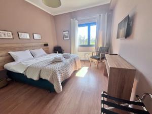 a bedroom with a bed and a desk in it at SUNNY 3, Two-bedroom apartment with parking in Komotini
