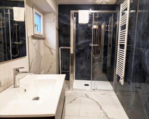 a bathroom with a sink and a shower at Le torri Virgo in Fossano