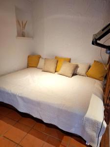 a large white bed with yellow pillows on it at Ferienwohnung Till in Mölln