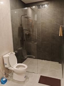a bathroom with a toilet and a glass shower at Umakami Pertiwi Villas in Ubud +3 photos