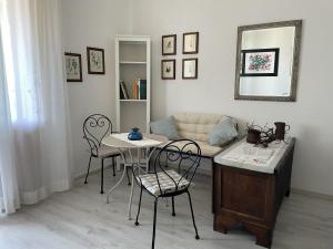 a living room with a table and chairs and a couch at Andrea E Valentina in S'archittu Cuglieri +36 photos