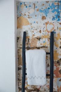 a towel hanging on a wall next to a painting at Nbta House in Tangier