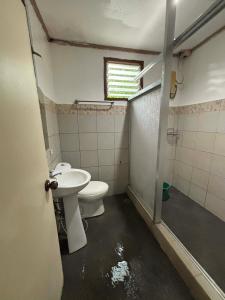 a bathroom with a toilet and a sink at Harmony Place at Hillside in Puerto Princesa City