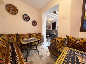 a living room with a couch and a table at Dar Jnan EL Sbil in Fez