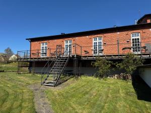 a brick building with a staircase on the side of it at Ravlunda Bränneri in Kivik