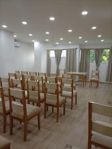 a room with wooden chairs and tables and windows at Adele Hotel in Ríohacha +85 photos