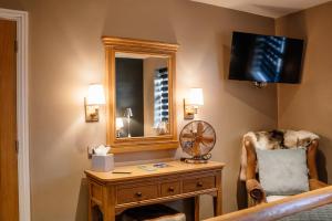 a room with a desk and a mirror and a chair at Blue Bell Country Inn in Knaresborough