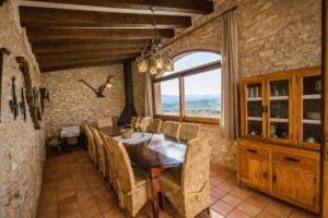 a dining room with a table and chairs and a window at Catalunya Casas Captivating Villa in the Vineyard close to Sitges in Bisbal del Penedès