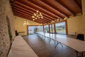a long long table in a large room with chairs at Catalunya Casas Captivating Villa in the Vineyard close to Sitges in Bisbal del Penedès +46 photos