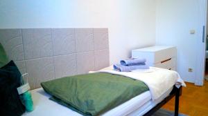 a bedroom with a bed with towels on it at Ferienwohnung Hanna in Bitterfeld