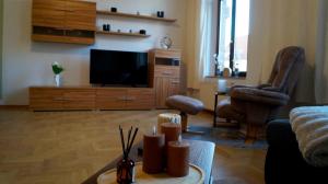 a living room with a couch and a tv at Ferienwohnung Hanna in Bitterfeld