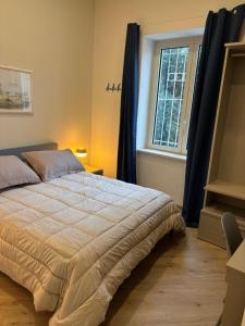 a bedroom with a large bed and a window at Notte di note in Pagani