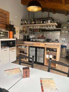 a large kitchen with a counter and a table at Pension San Anton in Melide