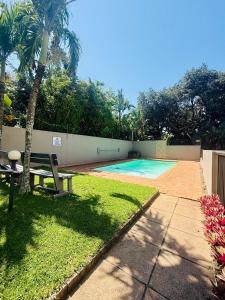 a swimming pool with a table and a bench in a yard at Deja Blue in Westbrook