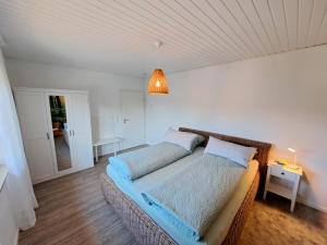 a bedroom with two beds and a light fixture at Ferienwohnung Wandelweg in Kamp-Lintfort