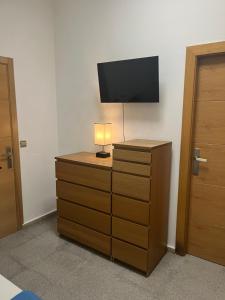 a bedroom with a dresser with a television on it at Habitaciones La MAR in Altea +25 photos