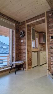 a kitchen with a bench in a room with a window at CHATKA u TADKA in Nowy Sącz