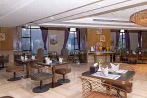 a rendering of a restaurant with tables and chairs at Violet Al Azizia Hotel MASJID Al Qatari in Mecca