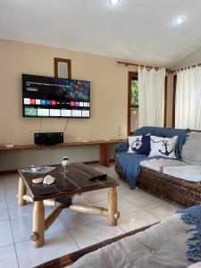 a living room with a couch and a table at Pousada Royale in Arraial d'Ajuda
