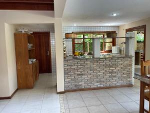 a kitchen with a brick wall in a room at Pousada Royale in Arraial d'Ajuda +226 photos