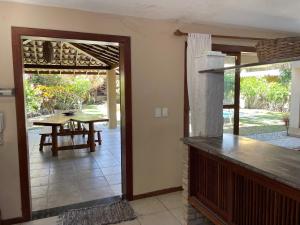 a kitchen with a table and a dining room at Pousada Royale in Arraial d'Ajuda