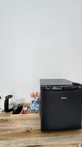 a black appliance sitting on top of a wooden table at Surf Villa Hiriketiya in Hiriketiya +62 photos