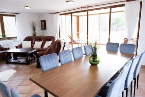 a dining room with a table and chairs at Club Apartments in Čeladná