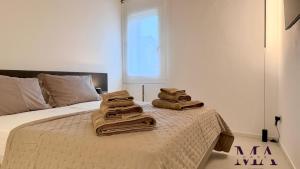 a room with a bed with towels on it at MAcase Apartments in Ferrara