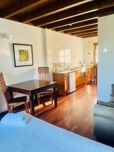 a room with a table and a kitchen with a bed at Apartamentos Monterodiles in Liñero