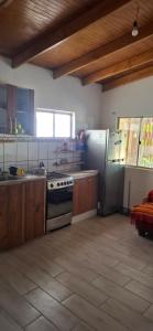 a kitchen with a stove and a refrigerator at Cabaña Laynaturi in San Pedro de Atacama