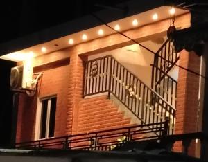 a brick building with a staircase with lights on it at Risha villa in Trincomalee