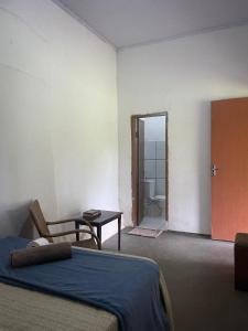 a bedroom with a bed and a door to a bathroom at Suite 3 in São Domingos
