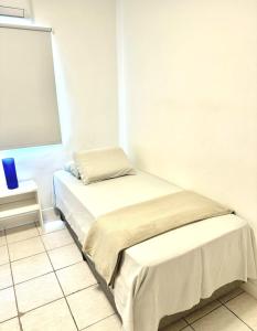 a room with two beds and a window at Pacífico Guest House Recife - Polo Médico e Universidades in Recife +7 photos