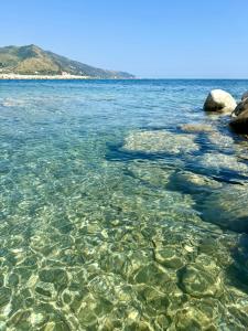 a body of water with rocks in it at Ripea Suites - Sul Mare in Montecorice +20 photos