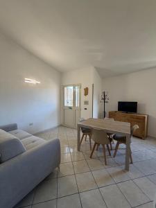 a living room with a couch and a table at Il Nido 1 di San Pietro in Budoni