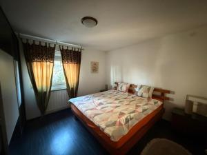 a bedroom with a bed and a window at Apartment AMRA in Tuzla