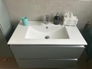 a white sink in a bathroom with a blue candle at Parrot House in Bertinoro +35 photos